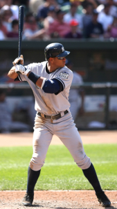 Person holding a baseball bat in the proper batting stance