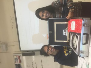 Annicia Bisnauth and Reya Bhoodai from Model UN showing us a model of Shop In a Box. 