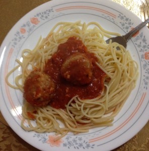 Vegan lentil balls served spaghetti and topped with marinara sauce. 