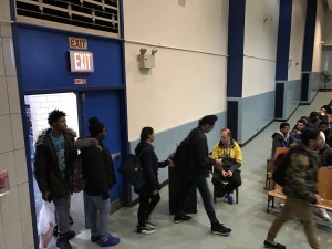 Late students arriving through the auditorium doors in the morning.