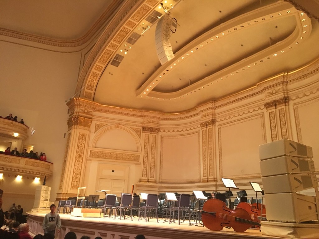 Carnegie Hall's stage is filled with seats and open music scores, awaiting to be filled with musicians to fill the theater with melodies. 
Photo Credit: Marilyn Ramos​​