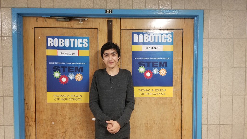 Caption: Jonathan Ustaev,  standing in front of his favorite class; Robotics
Photo Credit: Rickcarl Paningsoro