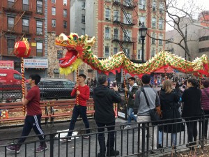 Caption for dragon: Performers carry a dragon through the crowd on poles to spread good luck in a traditional dragon dance. Photo Credit: Marilyn Ramos