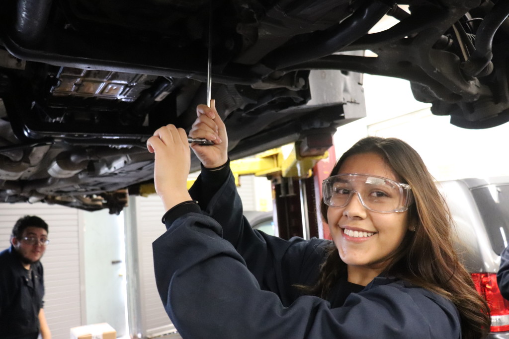 Cindy Ronquillo working on a client's car in the automotive shop.