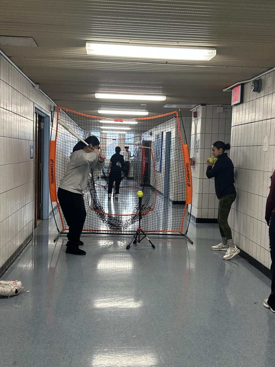 The girls softball club practices their swing indoors during the colder months.