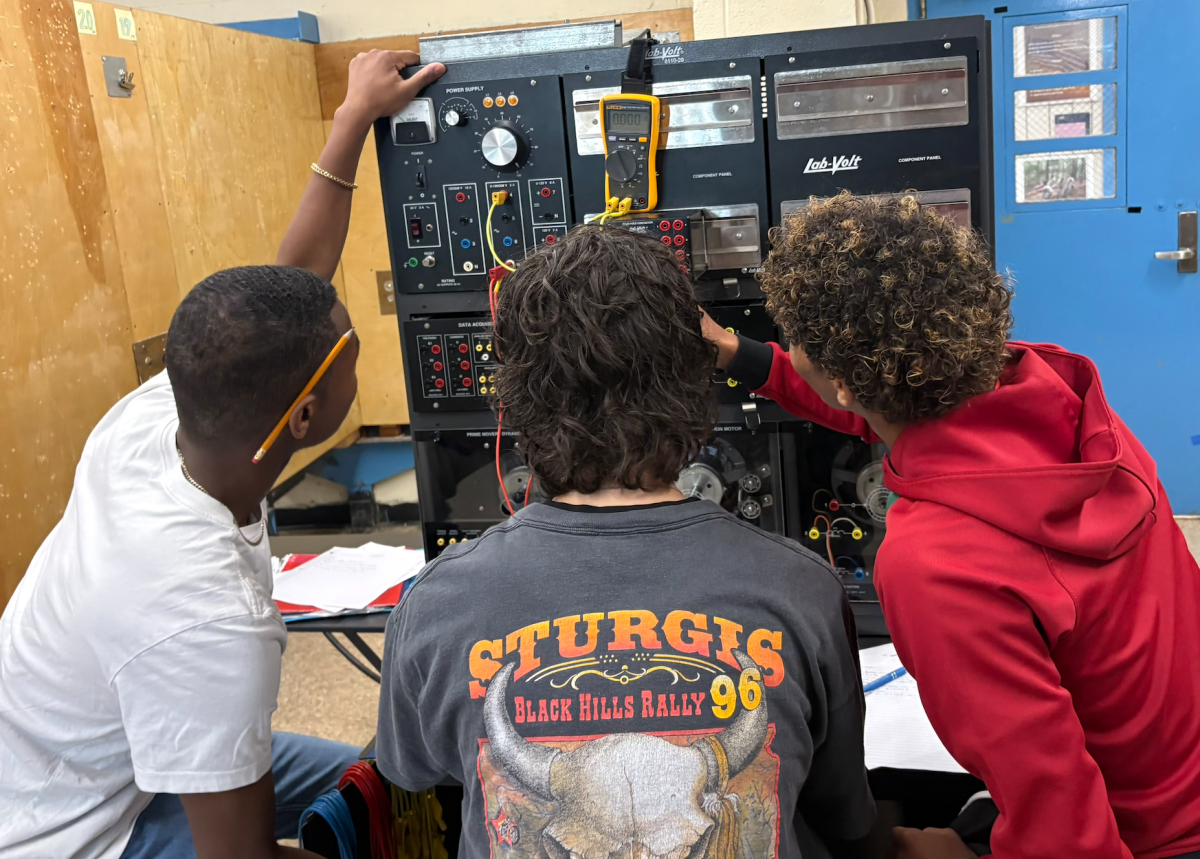 Students in Mr. Cooper's electrical shop learning how to correctly wire circuits.